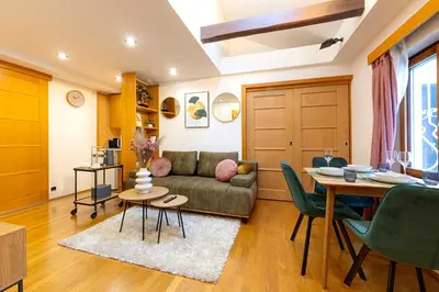 a living room with a couch and a table at The Wenceslas Loft in Prague