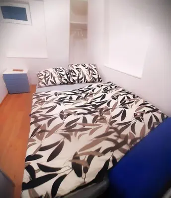a black and white bed in a room at Arbes apartman in Prague