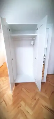a room with a white closet with a wooden floor at Arbes apartman in Prague