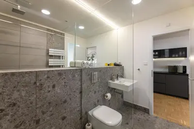 a bathroom with a toilet and a sink at KIP Old Town Modern Apartment with Free Parking & AC in Prague