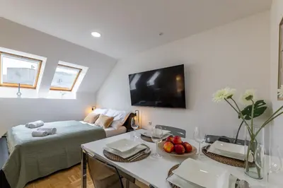 a living room with a couch and a table with fruit at KIP Old Town Modern Apartment with Free Parking & AC in Prague