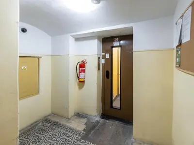 a hallway with a fire extinguisher next to a door at KIP Old Town Modern Apartment with Free Parking & AC in Prague
