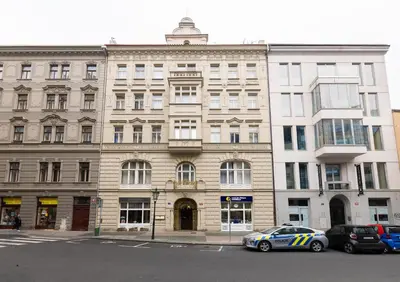 a police car parked in front of a building at KIP Old Town Modern Apartment with Free Parking & AC in Prague