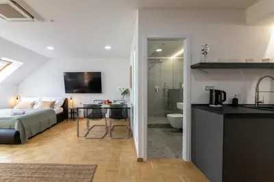a kitchen and a living room with a bed and a bathroom at KIP Old Town Modern Apartment with Free Parking & AC in Prague