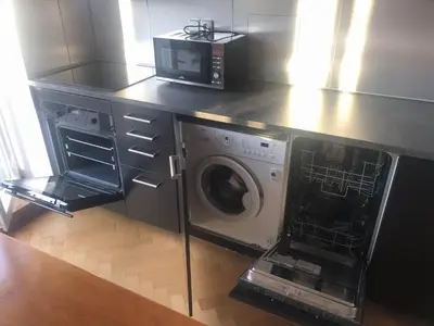 a kitchen with a microwave and a washing machine at Park View Apartment Anděl in Prague