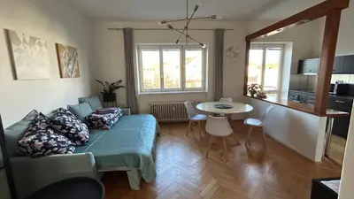 a living room with a couch and a table at Park View Apartment Anděl in Prague