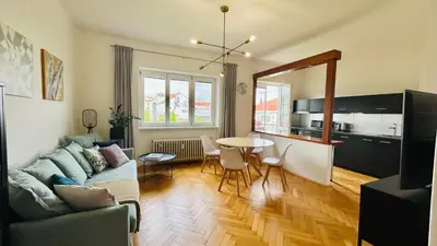 a living room with a couch and a table at Park View Apartment Anděl in Prague