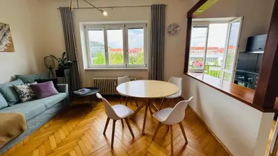 a living room with a table and a couch at Park View Apartment Anděl in Prague