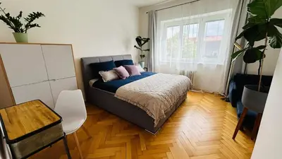 a bedroom with a bed with two pillows on it at Park View Apartment Anděl in Prague