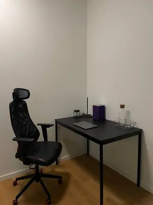 a black desk with a chair and a desk with wine glasses at Serene & Private Garden Oasis in Prague