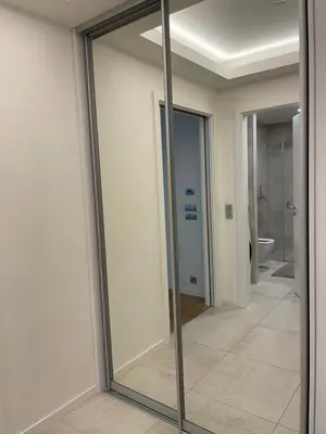 a glass mirror in a room with a bathroom at Serene & Private Garden Oasis in Prague