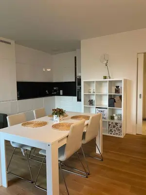 a white table and chairs in a kitchen at Serene & Private Garden Oasis in Prague