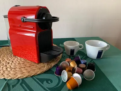 a red coffee maker and cups on a table at Apartments & Restaurant Tkalcovsky dvur in Prague