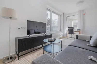 a living room with a couch and a flat screen tv at Blueground Prague 7 furnished close to offices PRG-22 in Prague