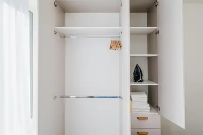 a walk in closet with white walls and white shelves at Blueground Prague 7 furnished close to offices PRG-22 in Prague