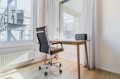 a desk with a chair in a room with a window at Blueground Prague 7 furnished close to offices PRG-22 in Prague