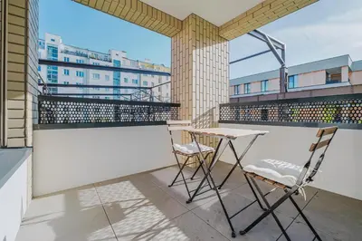 a balcony with two chairs and a table on a building at Blueground Prague 7 furnished close to offices PRG-22 in Prague