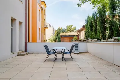 a table and two chairs on a patio at Blueground Vršovice private terrace equipped PRG-8 in Prague