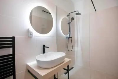 a white bathroom with a sink and a shower at Blueground Vršovice private terrace equipped PRG-8 in Prague