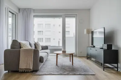 a living room with a couch and a tv at Blueground Prague 7 balcony Stromovka Park PRG-26 in Prague