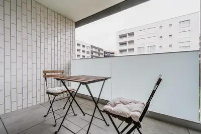 a table and two chairs on a balcony at Blueground Prague 7 balcony Stromovka Park PRG-26 in Prague