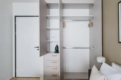 a bedroom with white walls and a closet at Blueground Prague 7 balcony Stromovka Park PRG-26 in Prague