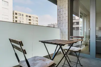a balcony with a wooden table and two chairs at Blueground Prague 7 balcony Stromovka Park PRG-26 in Prague