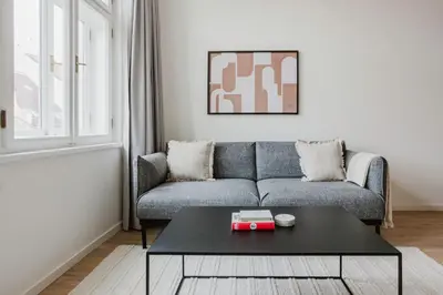 a living room with a couch and a table at Blueground Prague 2 renovated Náměstí Míru PRG-33 in Prague
