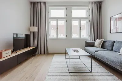 a living room with a couch and a tv at Blueground Prague 2 renovated Náměstí Míru PRG-33 in Prague