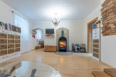 a living room with a fireplace and a glass table at Domeček na samotě in Terezín