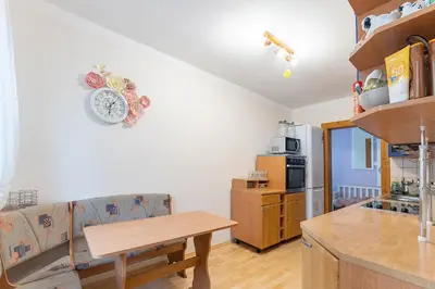 a kitchen with a couch and a table in a room at Domeček na samotě in Terezín