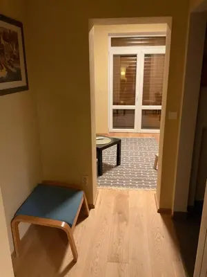 a room with a bench and a table and a window at Apartmán u lesa Nové Jirny in Nové Jirny