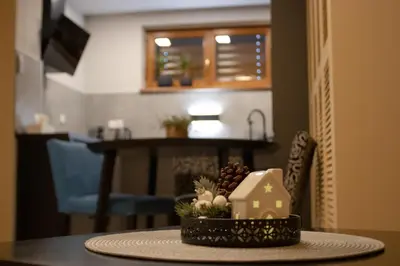 a table with a bowl of fruit and a house on it at Apartmán u lesa Nové Jirny in Nové Jirny