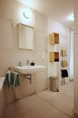 a bathroom with a sink and a tub and a mirror at Apartment Kosatcová in Prague