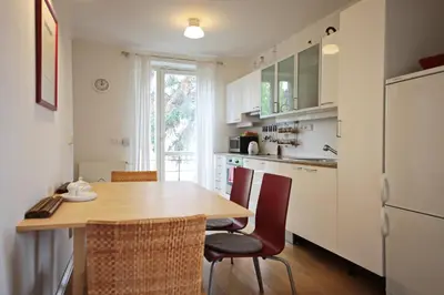 a kitchen with a table and chairs and a refrigerator at Apartment Kosatcová in Prague