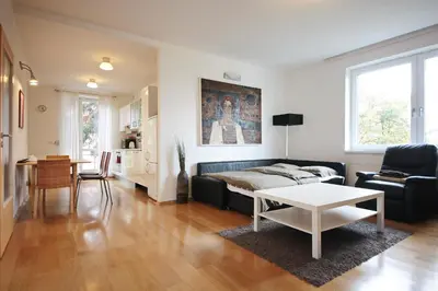 a living room with a couch and a table at Apartment Kosatcová in Prague