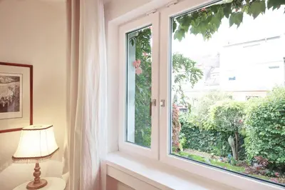 a window in a room with a lamp next to it at Apartment Kosatcová in Prague