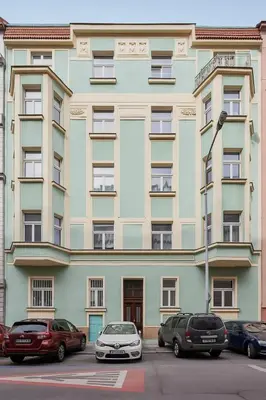 a large building with cars parked in front of it at Prague Days - Deluxe Loft with View in Vinohrady in Prague