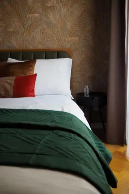 a bedroom with a bed with a red pillow at Rašínovo nábřeží - Riverside Residence in Prague