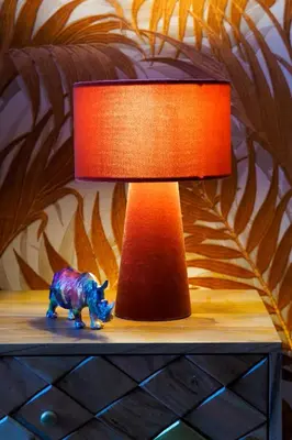 a lamp on a table with a toy rhino on it at Rašínovo nábřeží - Riverside Residence in Prague
