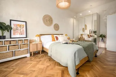 a bedroom with a large bed and a wooden floor at Prague Days - One-bedroom Apartment with Balcony and Workspace in Vinohrady in Prague