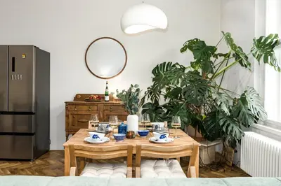 a dining room with a table and plants at Prague Days - One-bedroom Apartment with Balcony and Workspace in Vinohrady in Prague