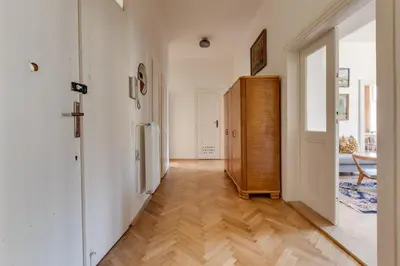 a hallway with white walls and a wooden floor at Prague Heart of Old Town Comfy Home 2BDR 2BATH in Prague