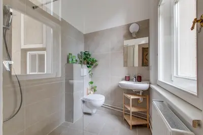 a bathroom with a toilet and a sink and a shower at Prague Heart of Old Town Comfy Home 2BDR 2BATH in Prague
