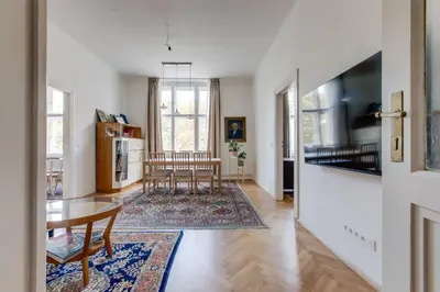 a kitchen and living room with a table and chairs at Prague Heart of Old Town Comfy Home 2BDR 2BATH in Prague