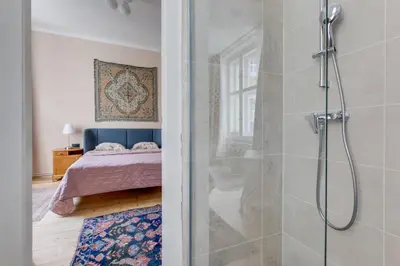 a bathroom with a shower and a bedroom with a bed at Prague Heart of Old Town Comfy Home 2BDR 2BATH in Prague