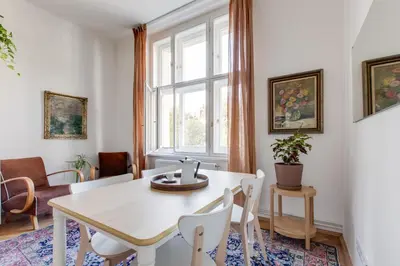 a dining room with a table and chairs and a window at Prague Heart of Old Town Comfy Home 2BDR 2BATH in Prague