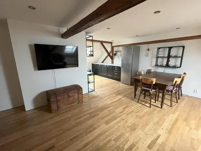 a dining room and kitchen with a table and chairs at Apartmán MUV in Mělník