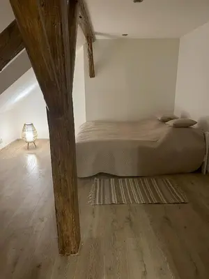a bedroom with a bed and a wooden floor at Apartmán MUV in Mělník