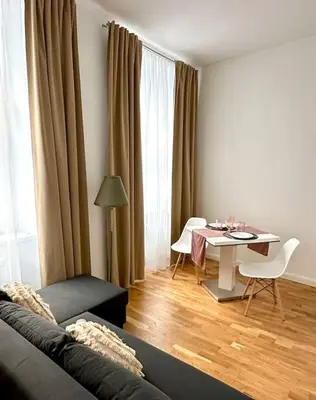 a living room with a couch and a table and a dining room at Prague Old Town Residence in Prague